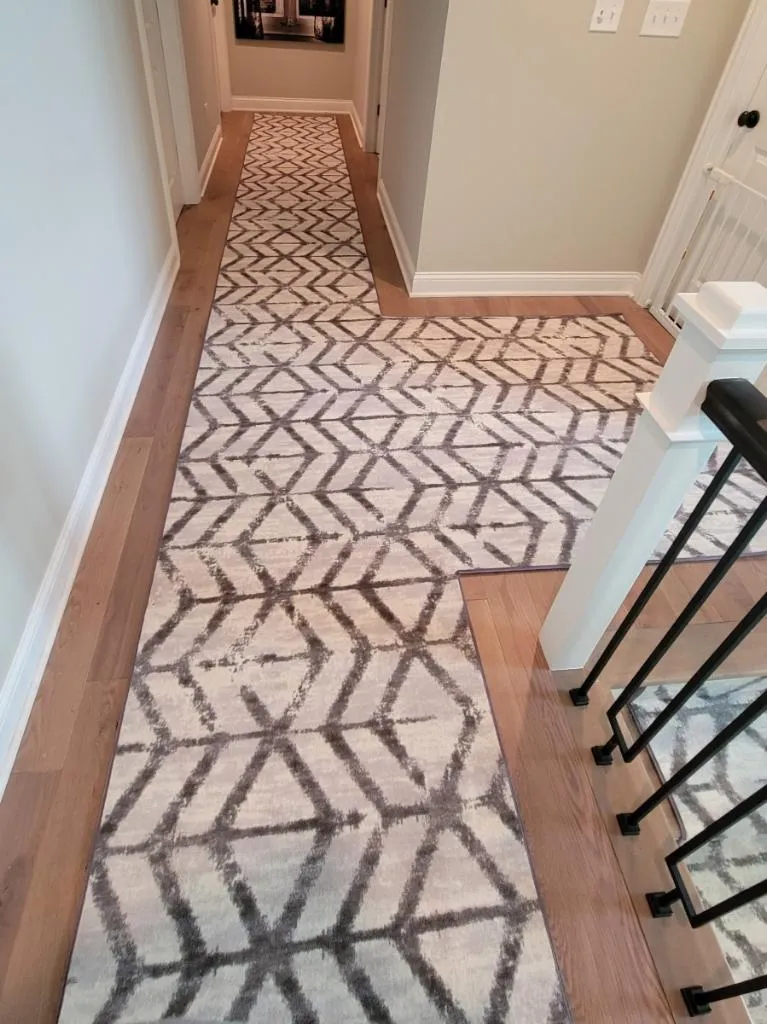 Patterned carpet and wood flooring