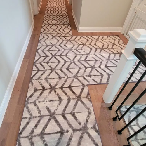 Patterned carpet and wood flooring