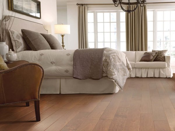 Timeless bedroom with hardwood flooring by McCools Flooring