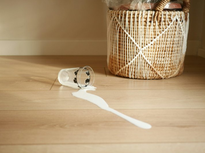 Laminate floor with a spilled glass of milk