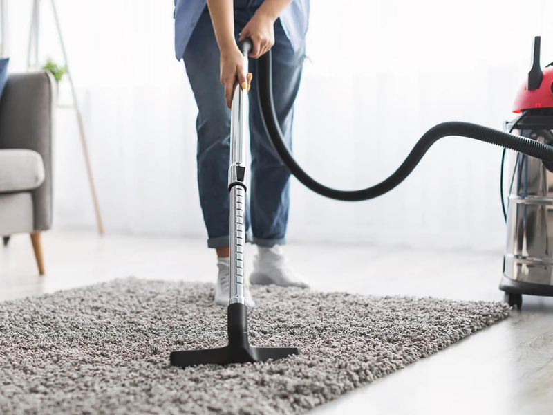 Vacuuming a shag area rug