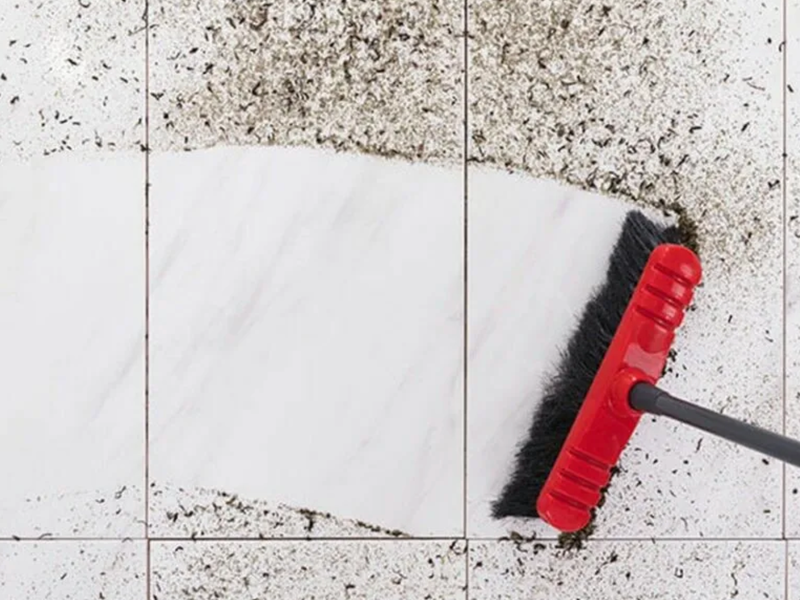 Sweeping dirt on a tile floor