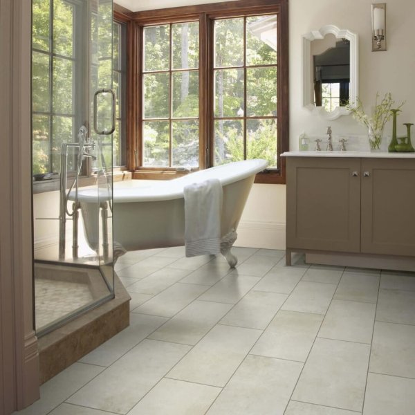 Charming bathroom with classic ivory tile floors