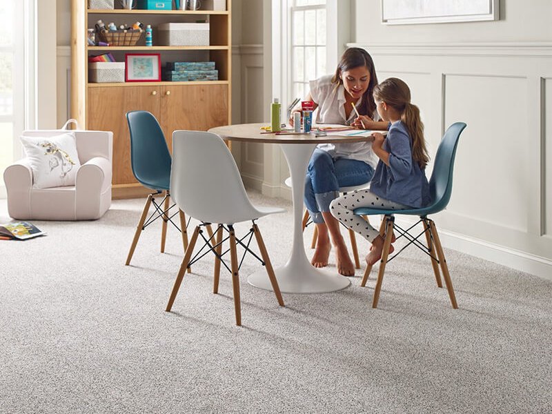 Mother and child in a cozy home with carpet flooring