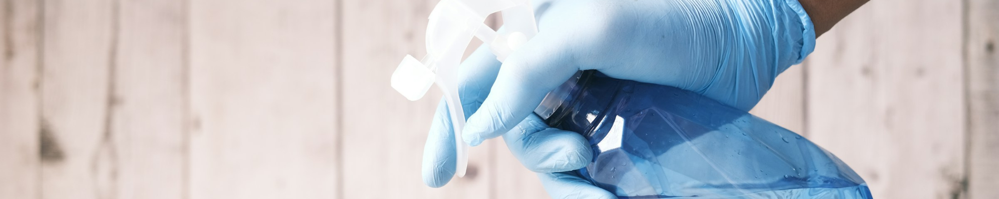 Spraying cleaner on a hardwood surface